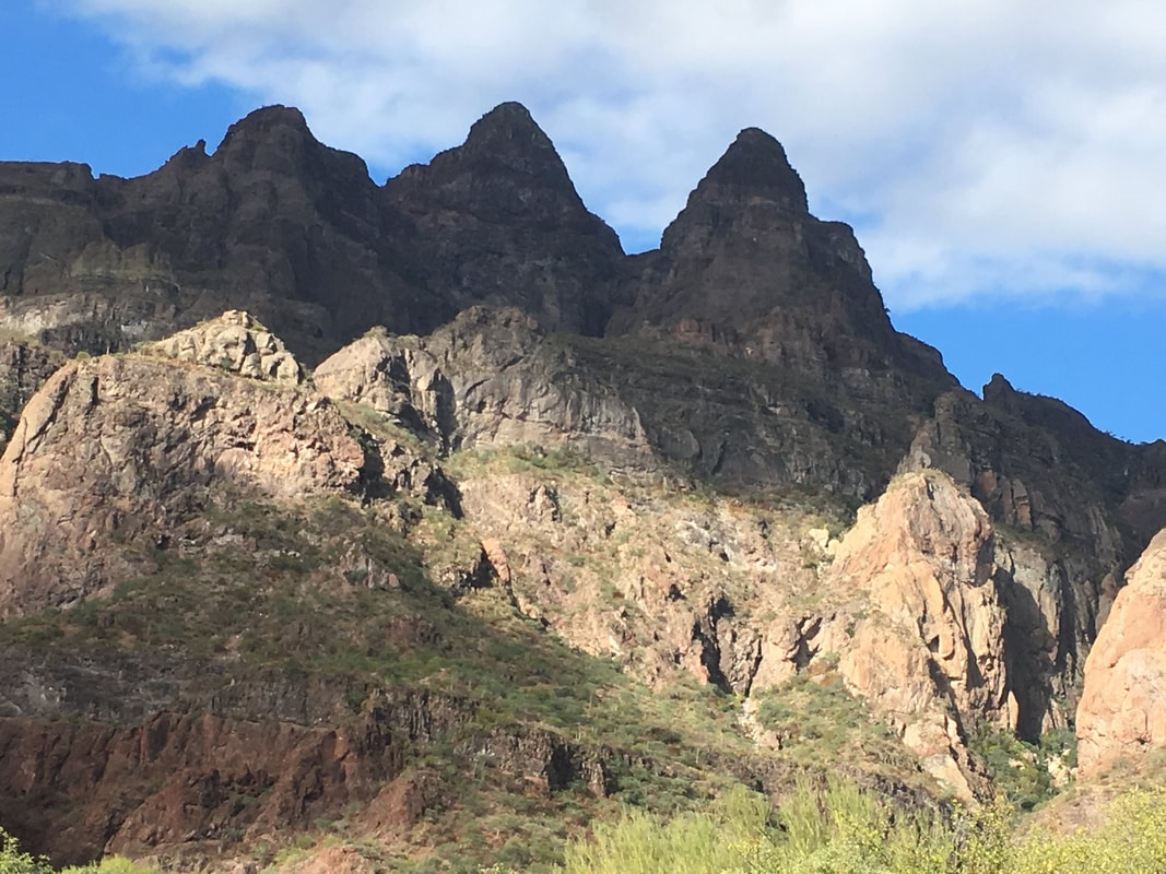 Hikers exploring a rocky desert canyon arroyo on a guided tour near Loreto