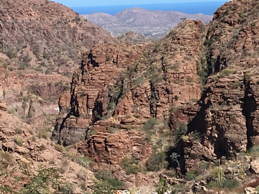 Narrow ridge trail with dramatic drop-offs in the Sierra de la Giganta