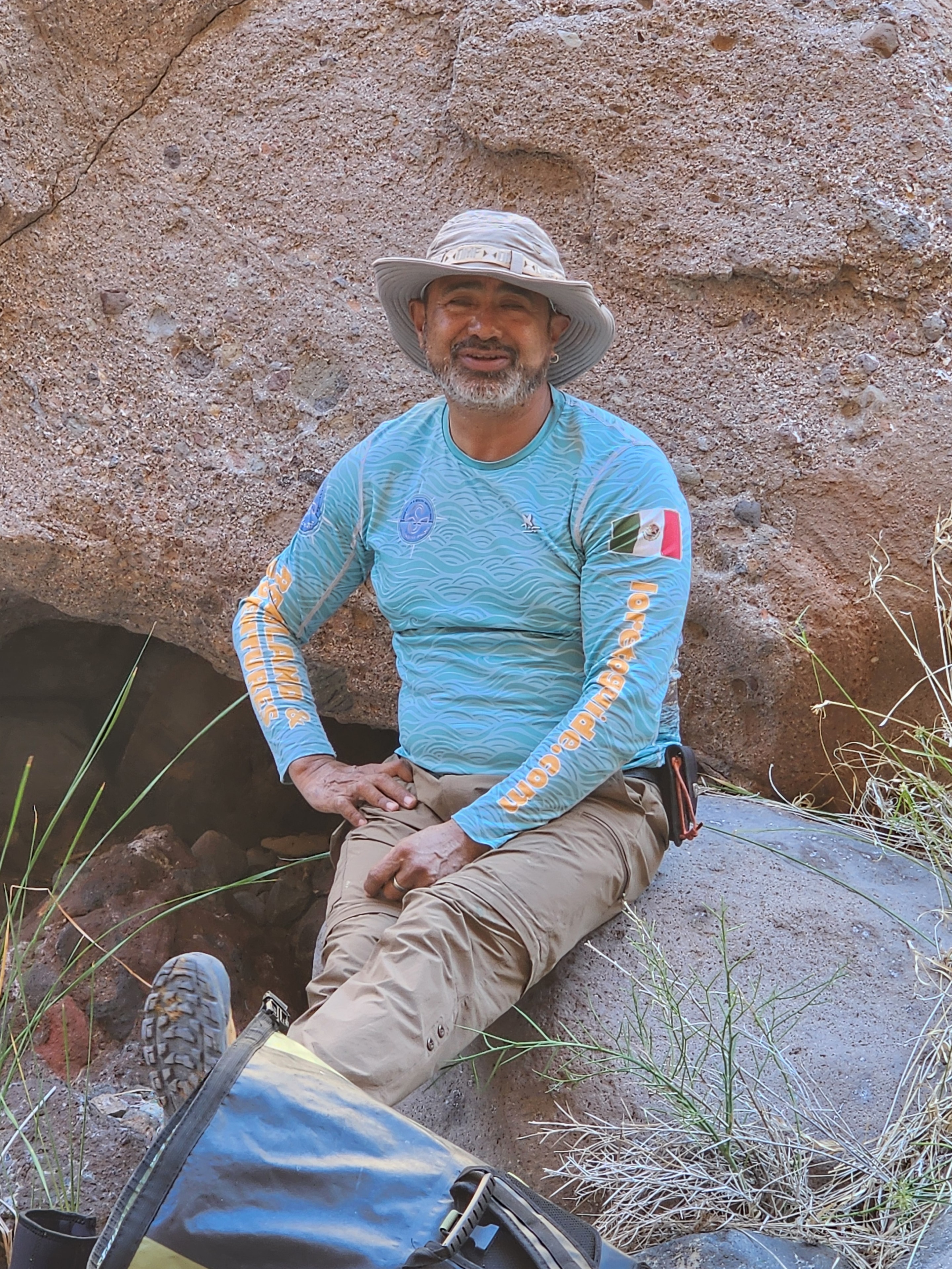 Said Orozco resting on a canyon rock during a guided hike near Loreto